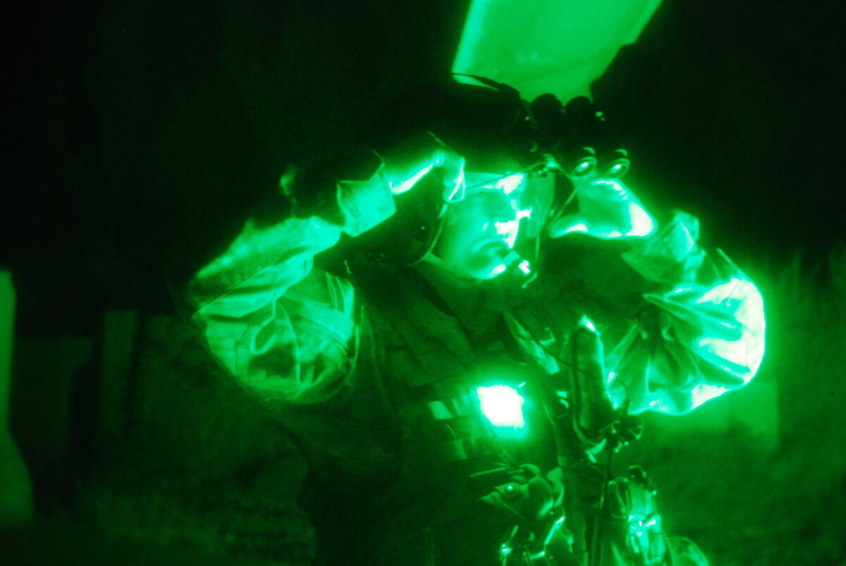 US Army soldiers wearing night vision goggles on a nighttime operation